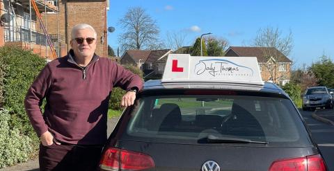 Jim, driving instructor, with his car